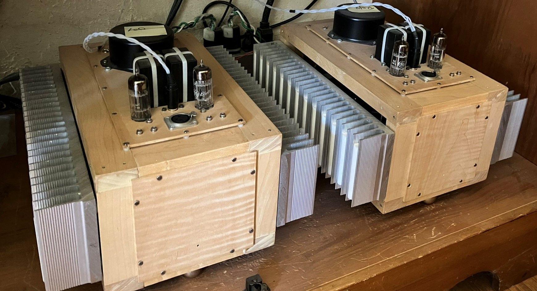 Cabinet bottom shelf with power amps.