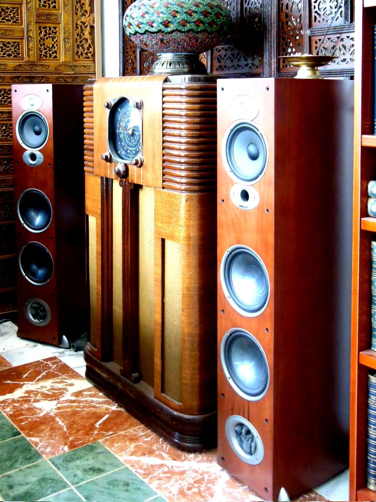 'Exotic' Corner of Main Listening Room.  At least the speakers here are in use--as rear reverb.  They're on a 12ms delay.  Polk RTiA7s with socks stuffed in their ports.  The Zenith is from 1936 and actually works, but of course I don't listen to it.  I may rig up some LEDs for its neato dial though. (Done now; photo forthcoming.)  What's exotic here?  The WAF sound-diffusing panels (the carved woodwork imported from Burma), Italian marble flooring, and the lantern which I found in Istanbul.