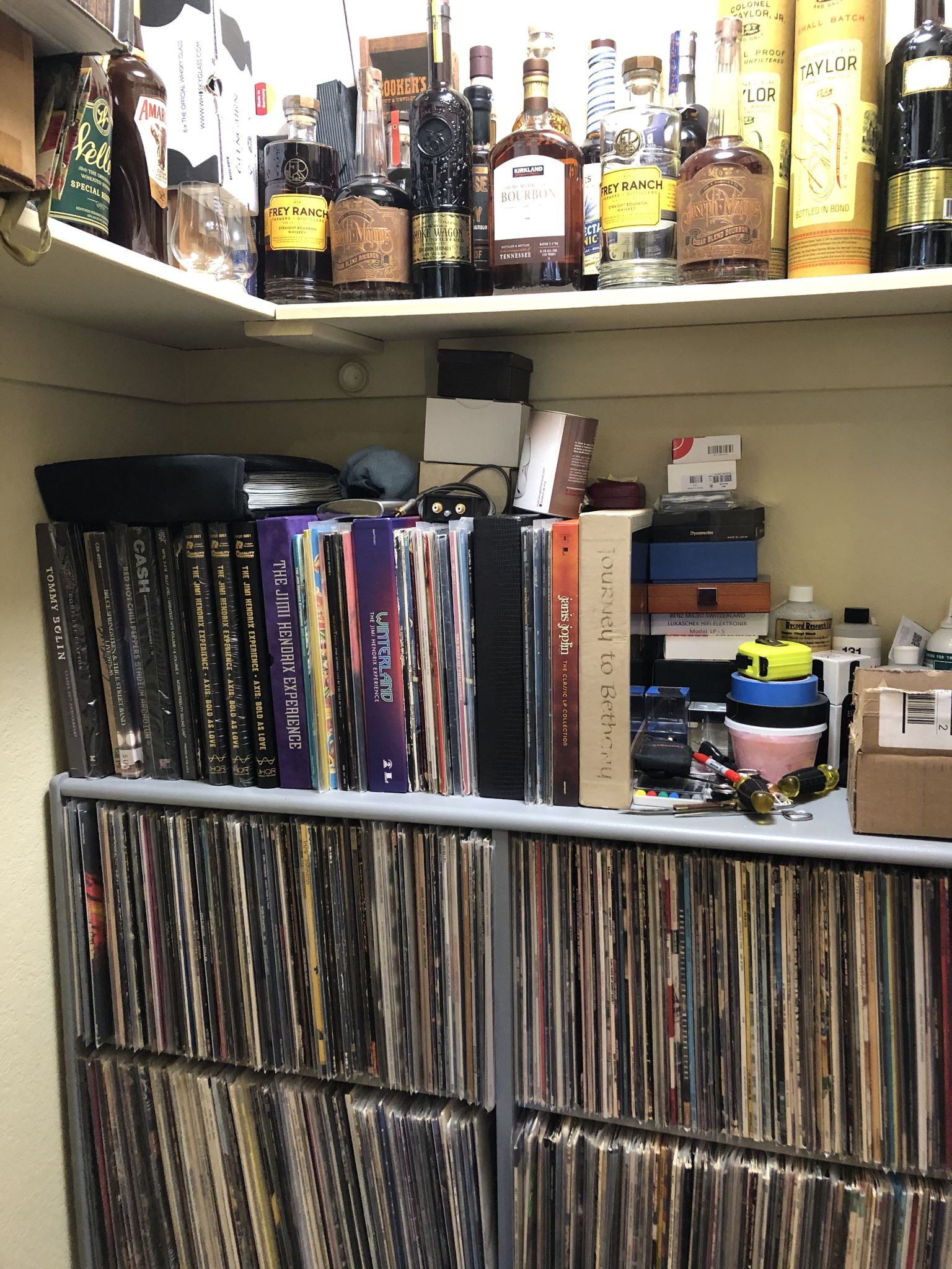 Records in closet rack with libations above