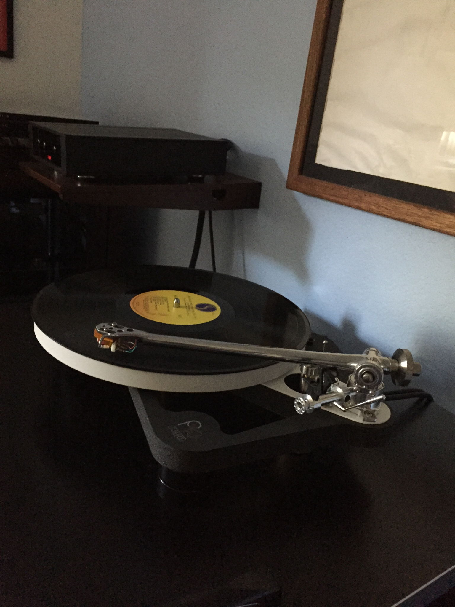 Turntable on the rack and the control unit on a separate floating shelf, mounted to the wall, along side the rack.