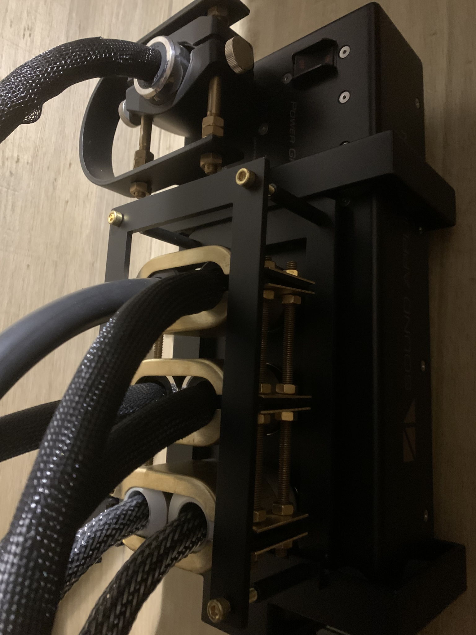 Power bank with custom brass clamp system to anchor connectors to their ports.
