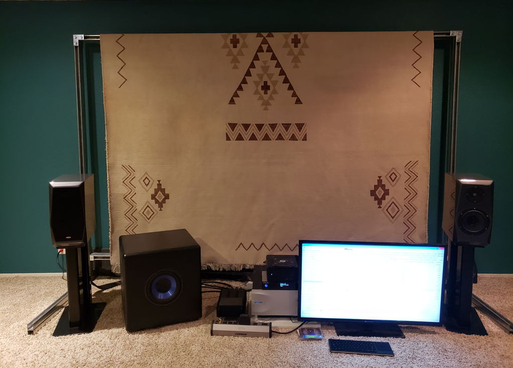 A big wollen rug, draped over a steel frame