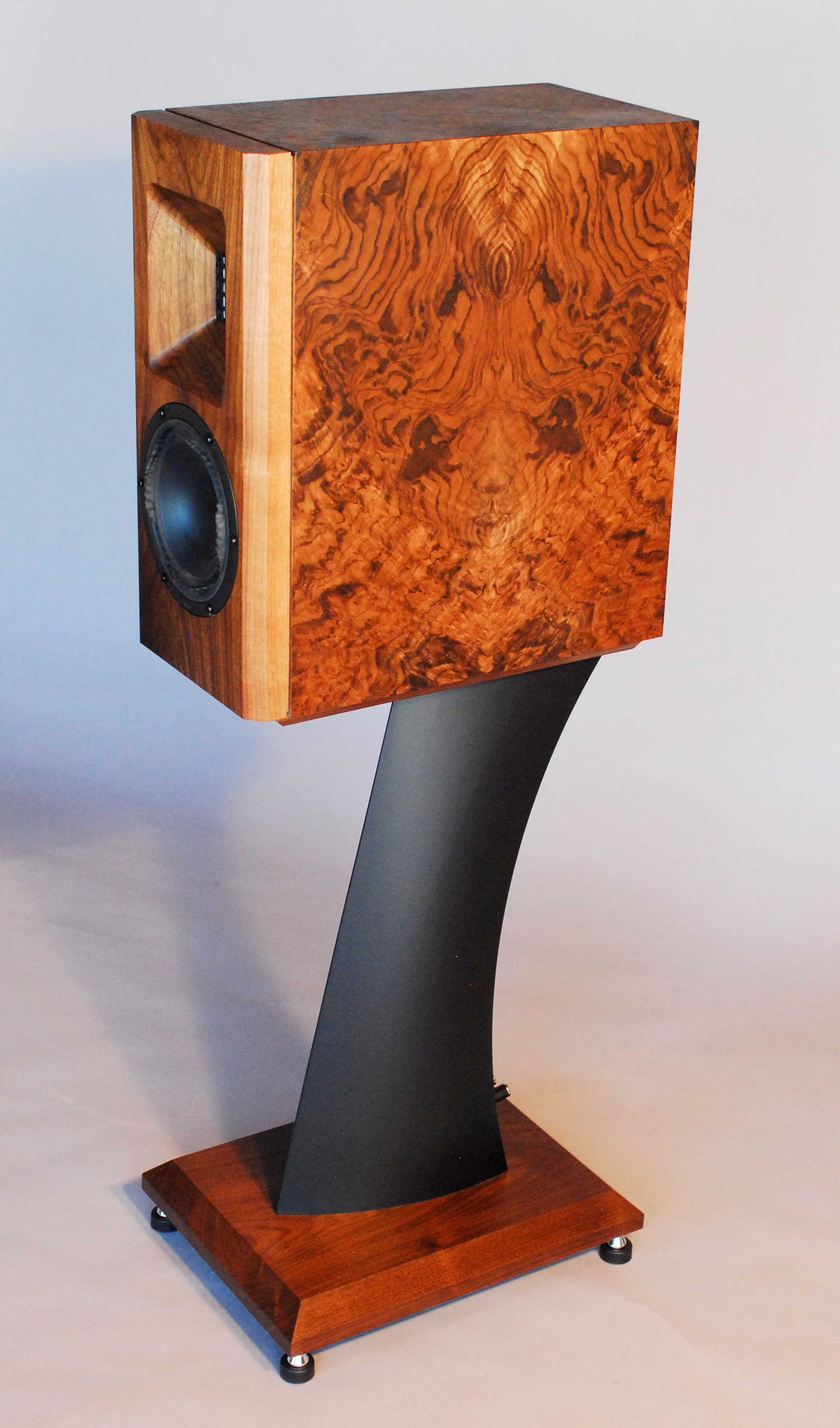 LS-6 in burl walnut veneer with solid walnut baffle on black stand.