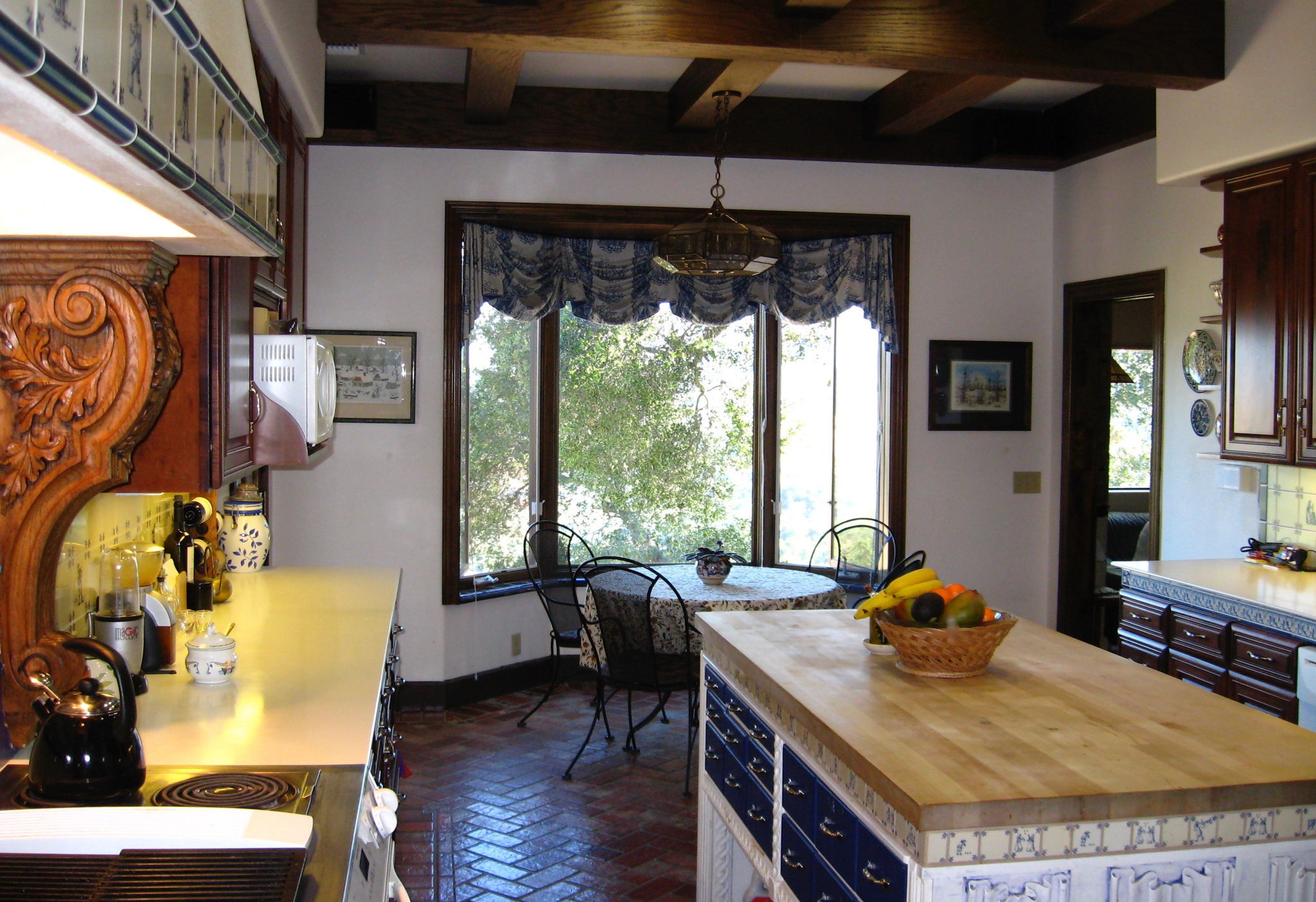 The kitchen has two Polk Audio speakers up high, invisible against the beams—for ambience while preparing meals.