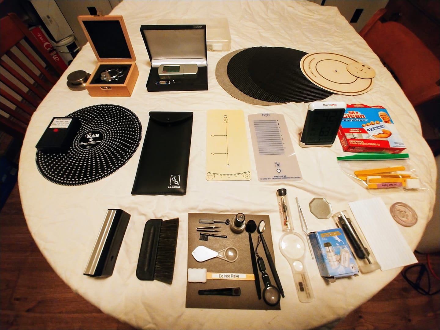 These are the tools lined up like a fighter bomber's weapons cache. I have acquired these over the years to keep a turntable set up properly. I know personally maintaining a vinyl rig can be a PITA but its a hobby of mine and I'm in the generation that grew up with records. It can be quite rewarding when you have set up everything just right. Top row left to right. Turntable weights, Digital stylus gauge and various mats. Middle row. Laser speed strobe 99.99 % accurate. Protractor for cartridge alignment. Temperature and hydrometer to monitor humidity in the winter to keep the record surface noise in check. Homemade stylus cleaner made with Mr. Clean magic eraser. Hands down the best you can use but don't rake. It might take the needle off. Bottom row. Record brushes. Stylus cleaning and inspection tools.  Oh my going rate for setting up a turntable is $150 hr. But for my FB friends I'm offering a limited time 100% discount. Happy spinning.