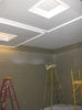 Hanging 6'x6' wood frame acoustic "clouds" with all-thread from the ceiling joists room centered.