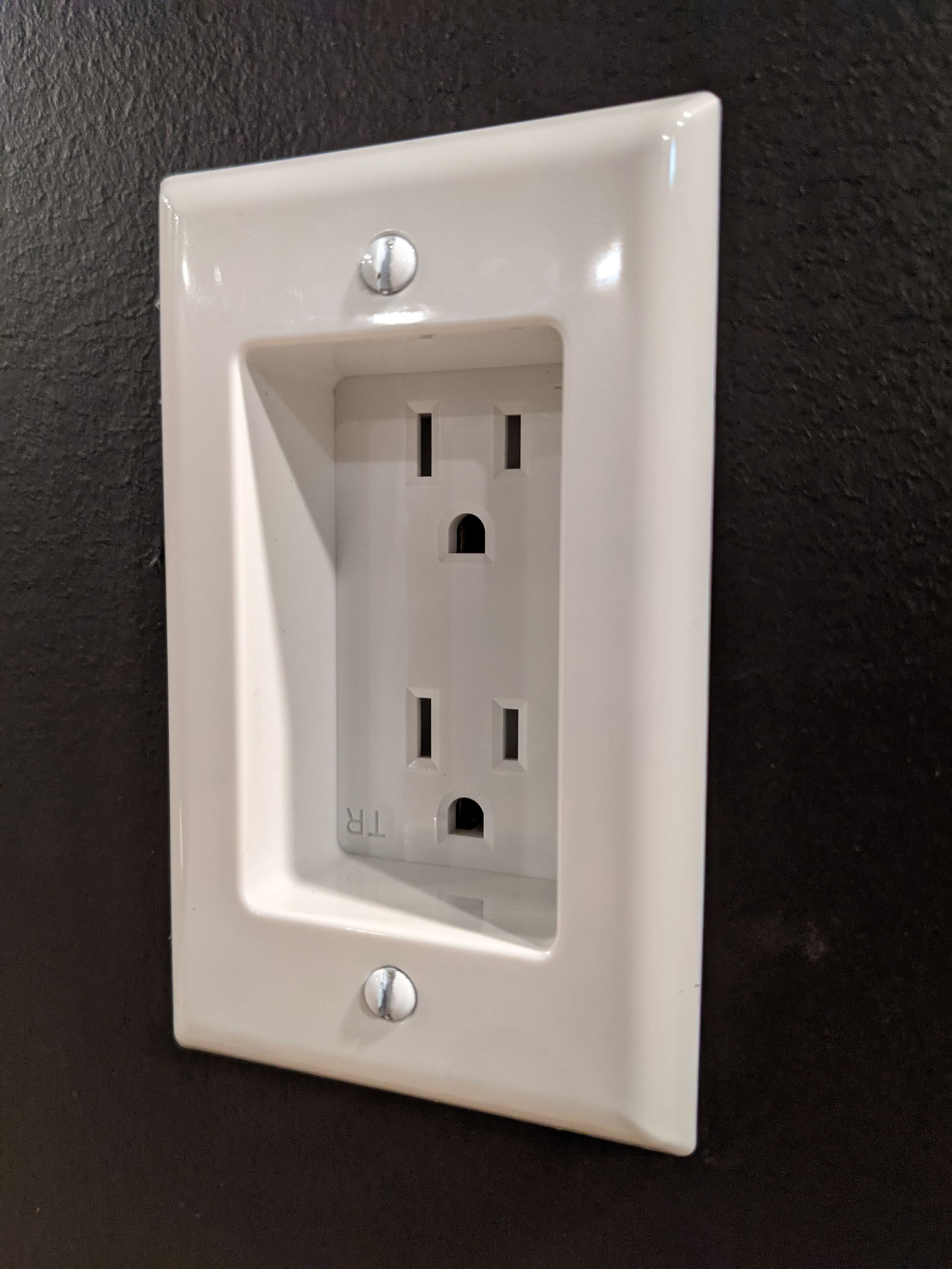 Recessed outlet for behind TV. White so I can see it when I look behind the TV. ;)