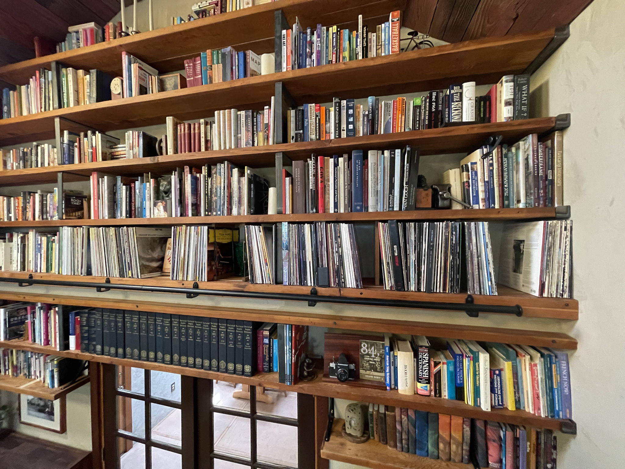 Shelving area. Shelf directly above rail stores plurality of albums. Classical from Bruckner to Vaughn Williams, Rock.