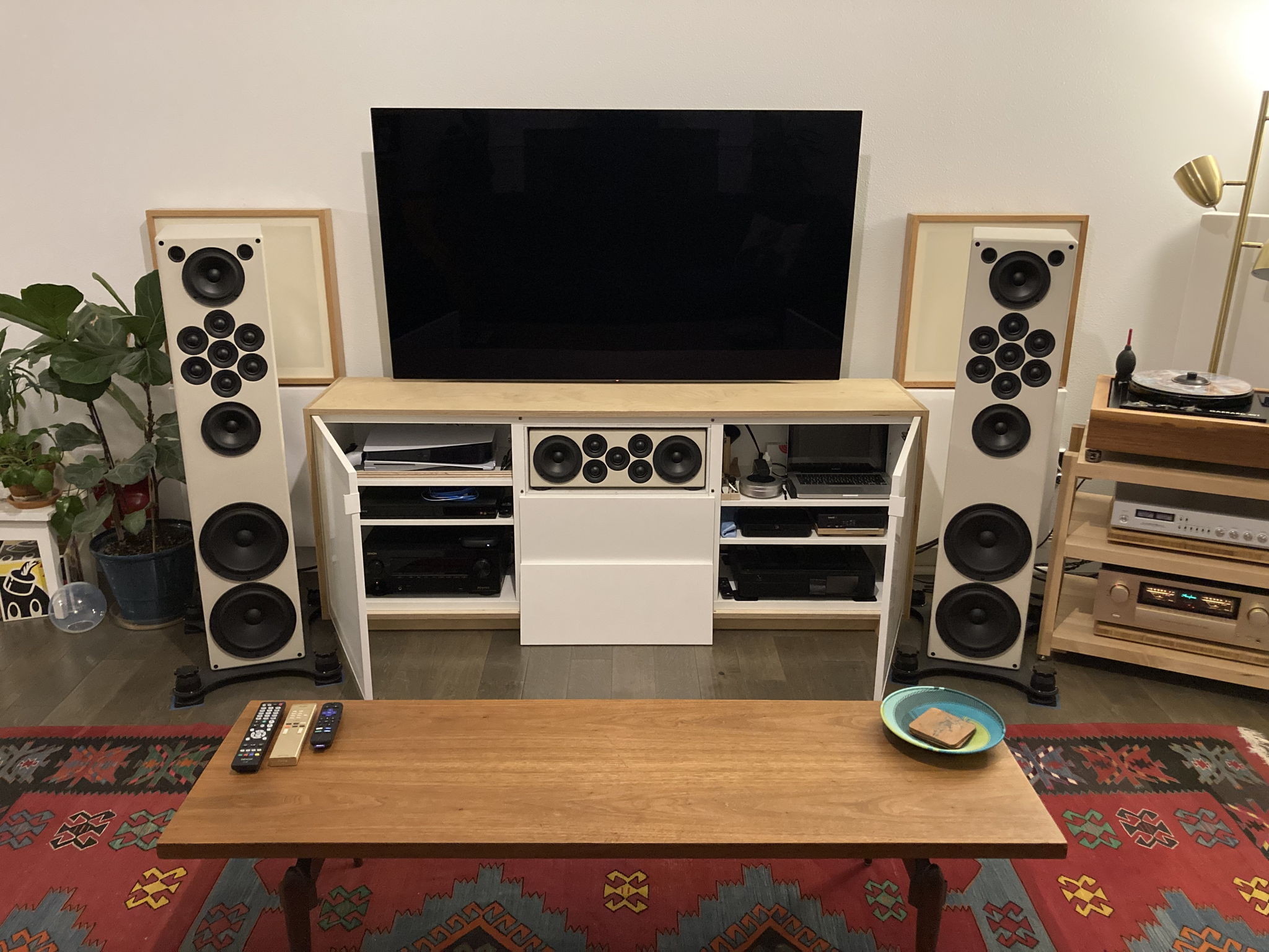 Panel removes for movie viewing. Equipment stored in Ikea credenza. 