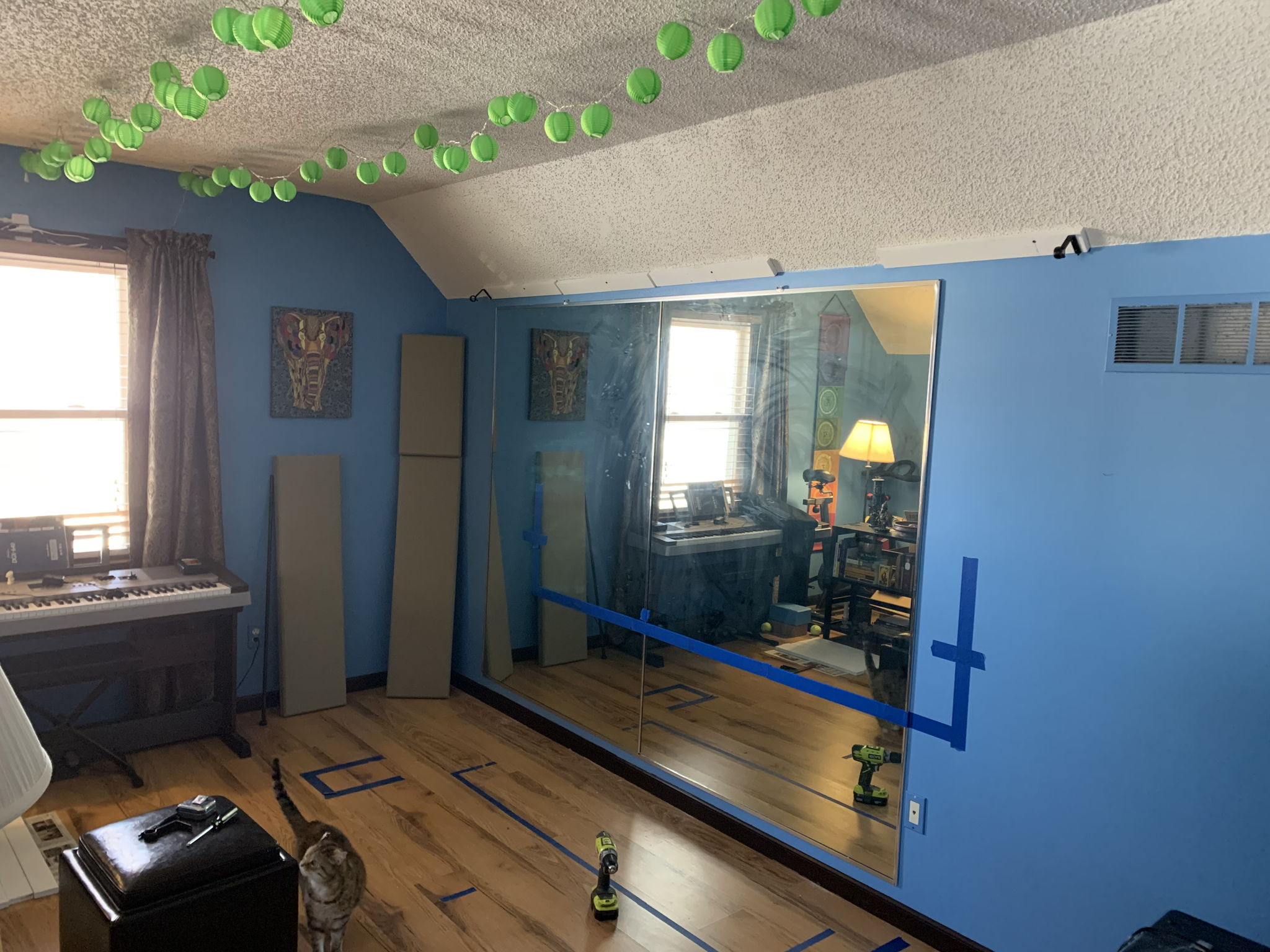 Marking screen and stereo speaker positions with painter’s tape. And Bea supervising, of course. The large mirrors are now covered with a blanket and curtains. 