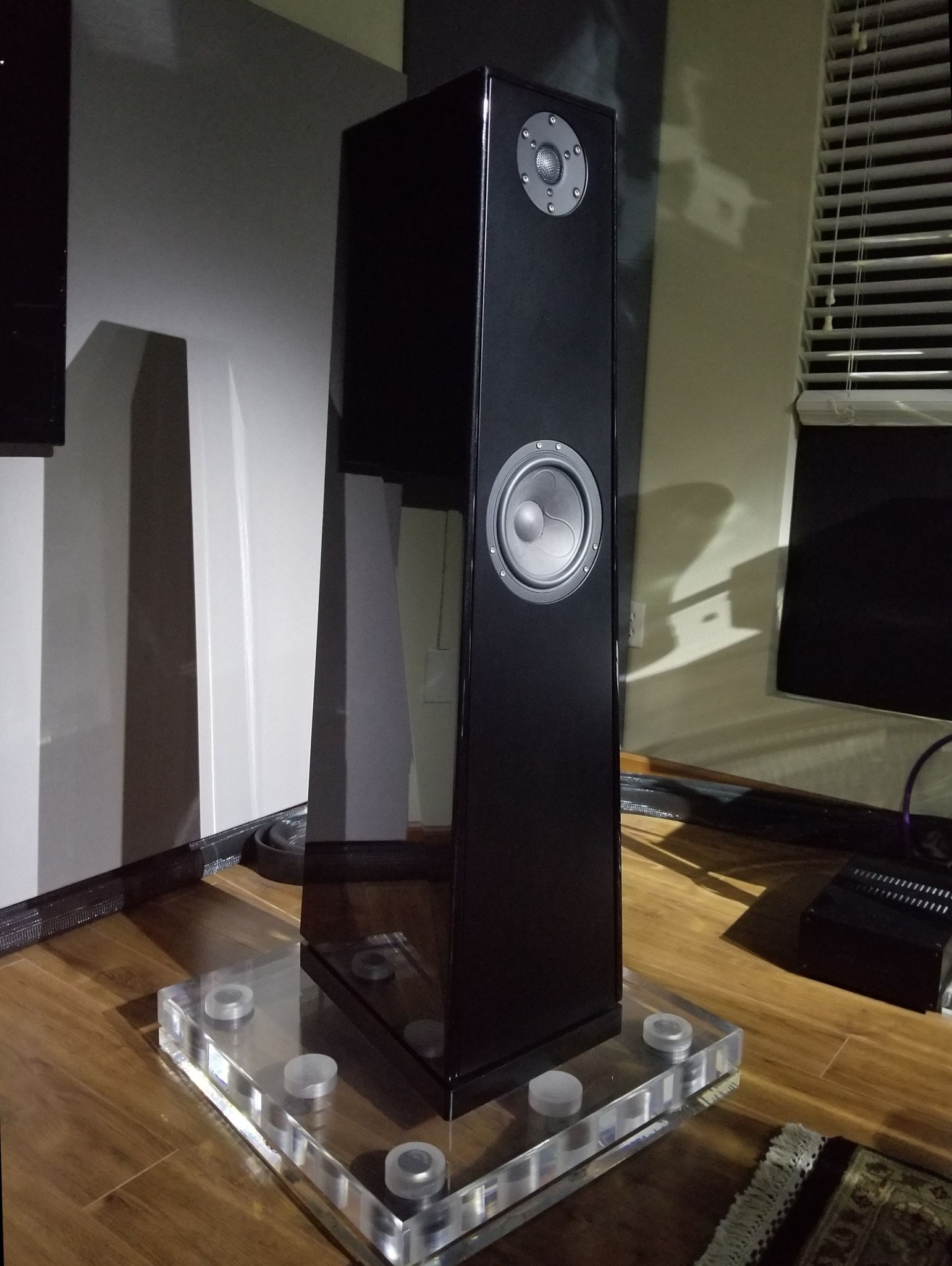 Acrylic bases under the speaker, sold separately.