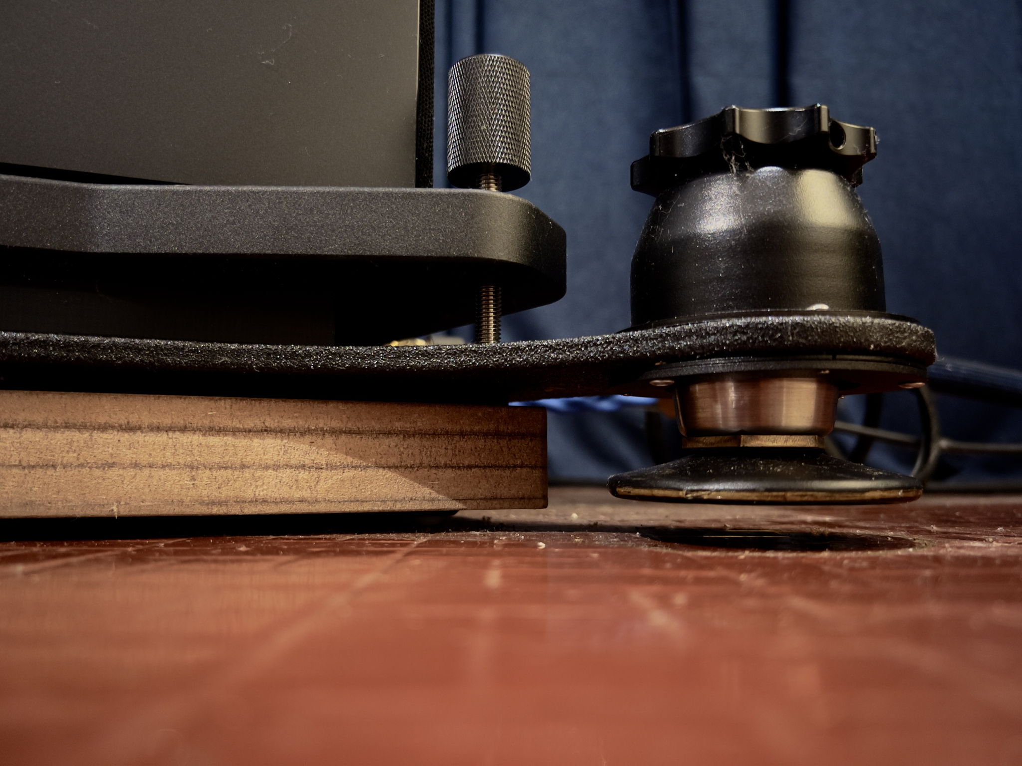 Corner of speaker / plinth base showing clearances - the isolation podium feet drop between 9mm to 16mm once weight has been taken off them, and the plinth thickness has to account for the additional dimension for the feet to clear the floor