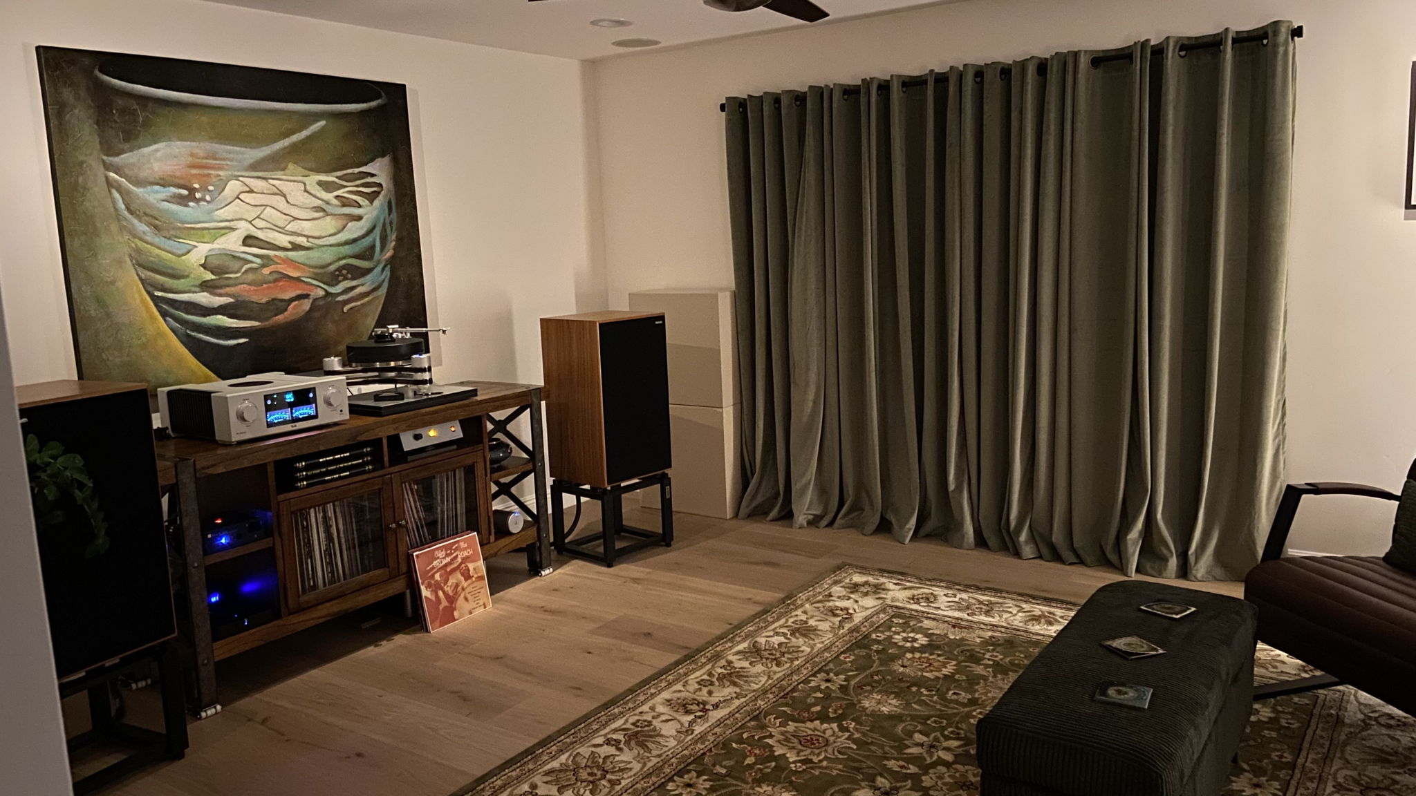 Small bay window behind drapes with panels at early reflection points