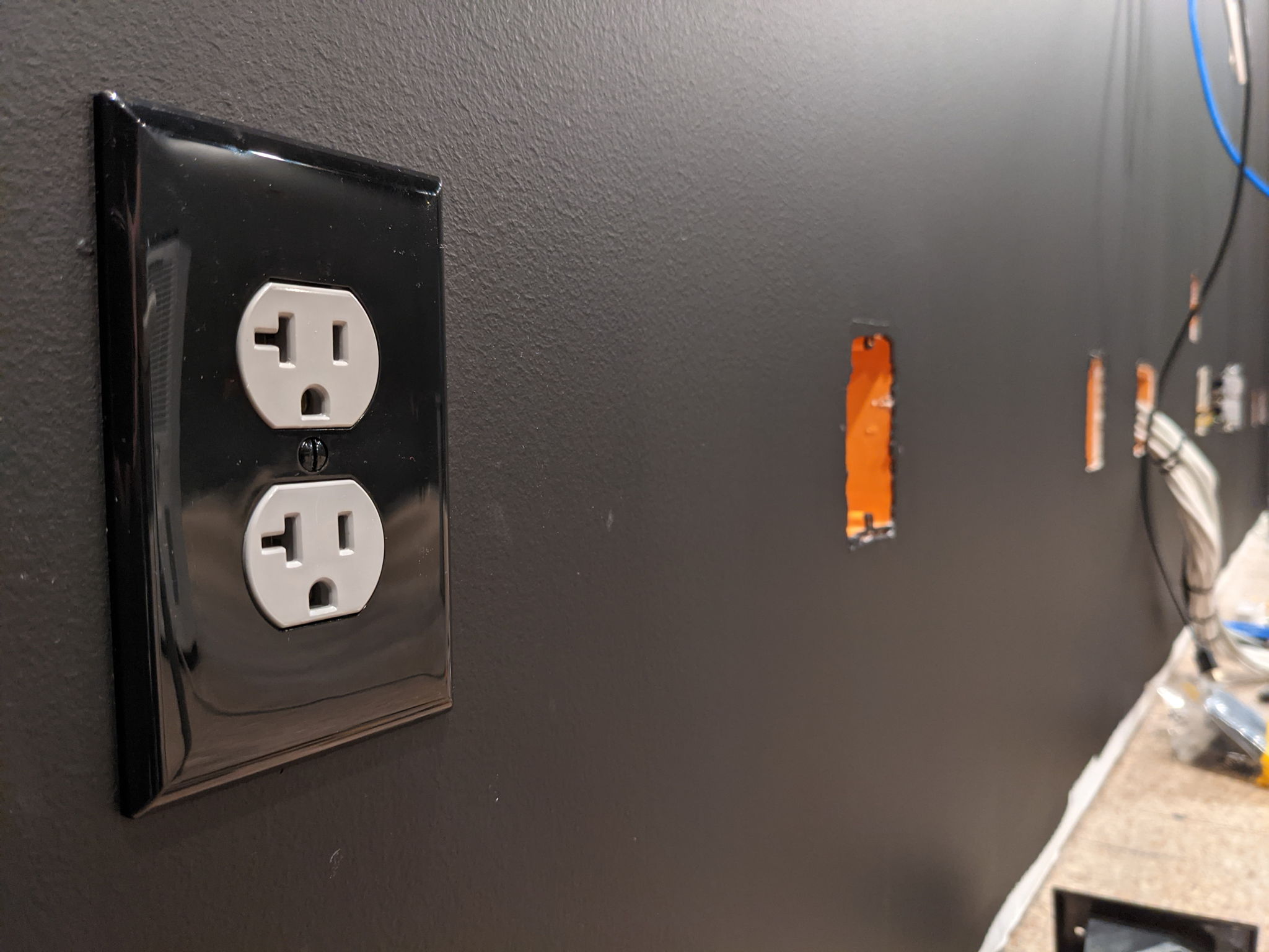 Grey and black outlets for the rest of the room so match the walls.