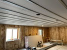 Ceiling with 5/8" drywall and RC channel awaiting next layer beneath