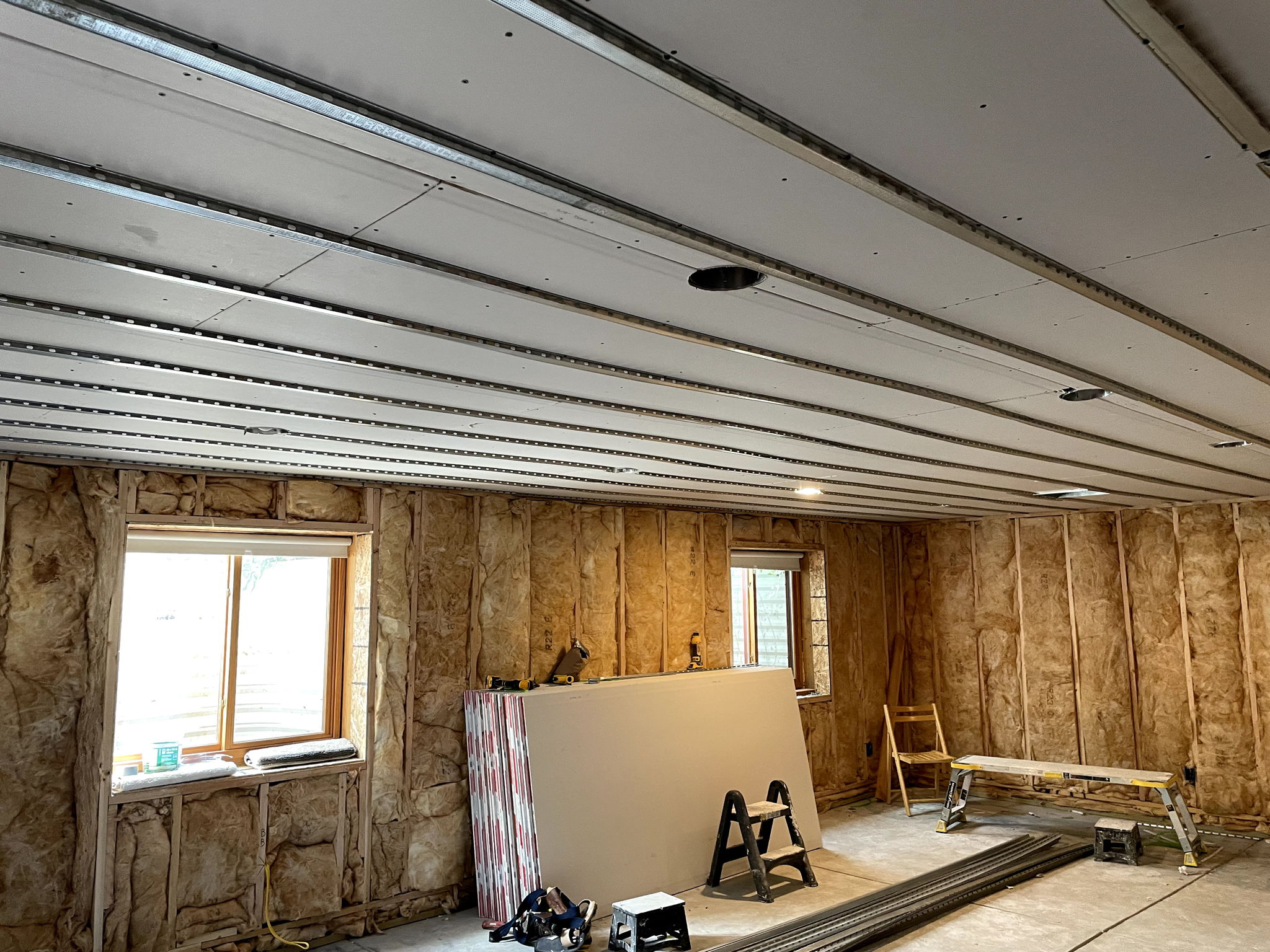 Ceiling with 5/8" drywall and RC channel awaiting next layer beneath